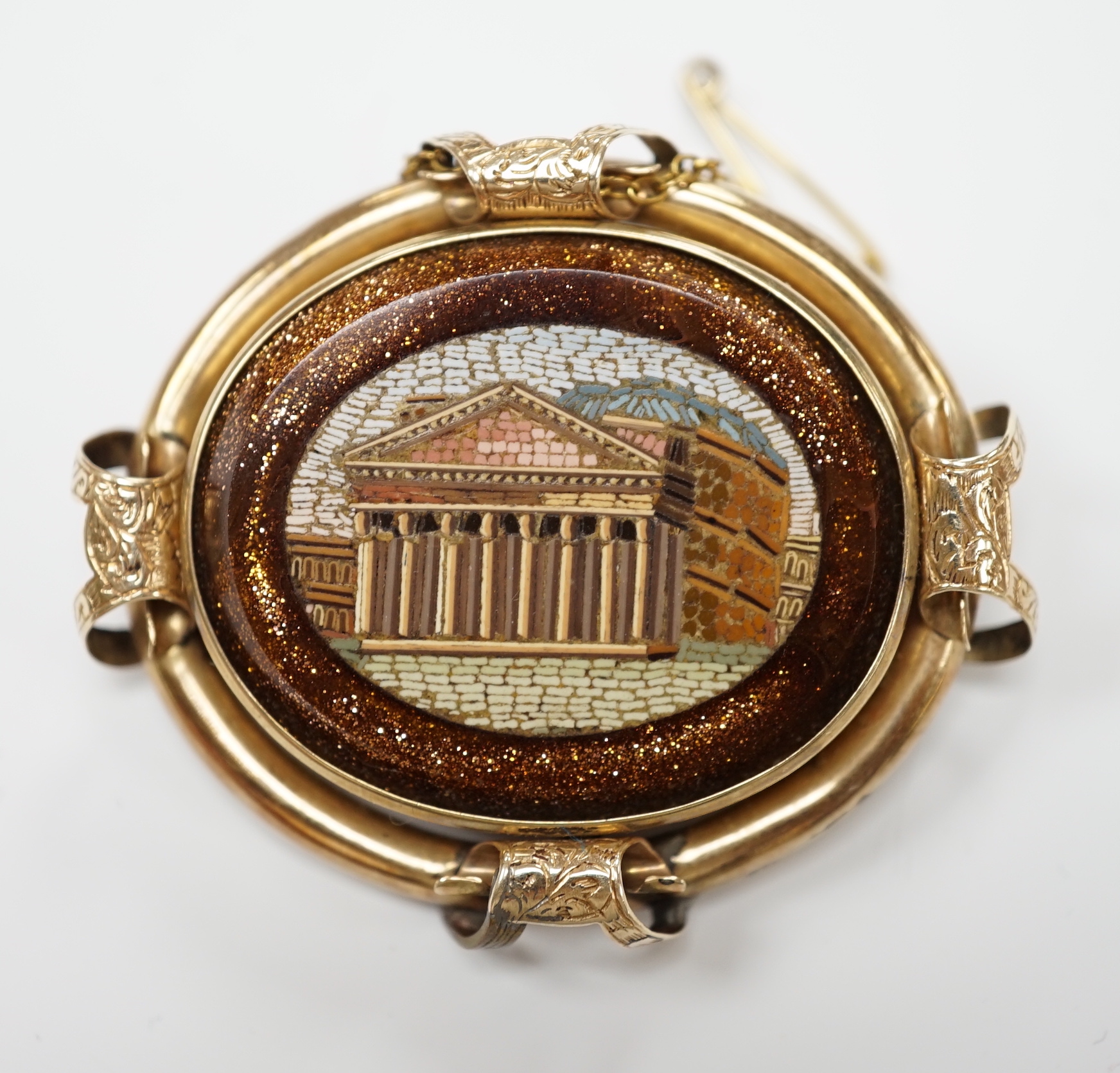 A Victorian yellow metal mounted goldstone and micro mosaic set oval brooch, decorated with the Pantheon, 49mm, gross weight 21.9 grams.